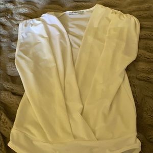 Cream sleeveless bodysuit.